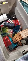 Open tote showing plastic drinkware, wooden knife block, small jar