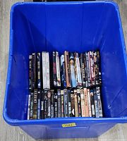 Blue tote containing two rows of DVD and Blu-ray discs, spines visible