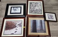 Overview of four framed prints on floor