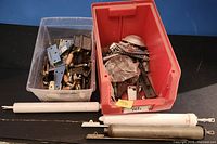 Clear bin with numerous metal hinges and wooden-grip lever handles
