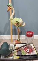 Full lot view showing flamingo statue, feeder and trays