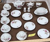 Full layout of tea set pieces on table