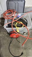 Overall lot showing retractable reels, loose hoses, air blow nozzle, and hardware in plastic bin