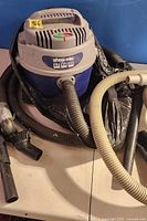 Shop-Vac canister with hoses attached