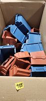 Box containing mix of blue and red stackable plastic bins