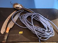 All items in lot: two saw blades and inspection trouble light with long blue cord