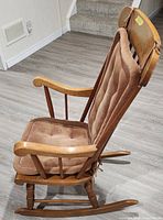 Side view of wood rocking chair with cushions attached