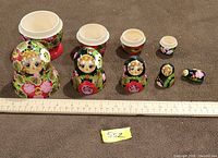 All nesting dolls displayed with halves separated to show interior and scale