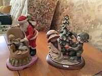 Both figurines side by side on table