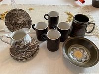Group shot showing all ceramics: bowl, mugs, stein, plates, creamer