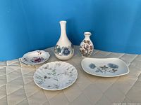 Group view of both vases and three dishes