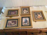 Group view of all five gilt-framed miniature prints