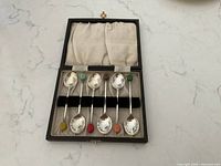 Closed case opened showing six silverplated spoons inside