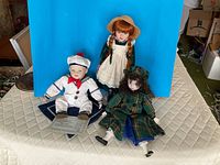 Group shot of three dolls on display
