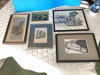 All five framed artworks laid out for overview