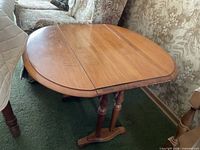 Table with both leaves raised forming oval top