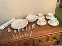 Full lot view showing china pieces and flatware