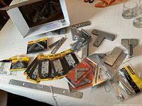 Overall lot of packaged Stanley hinges, corner braces, loose T-plates and mending hardware