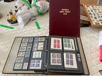 Maroon Double Mint Sheet File beside open binder showing mint stamp sheets