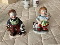 Front view of both Occupied Japan porcelain figurines