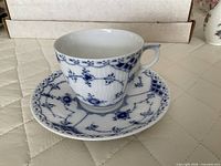 Teacup on saucer, Blue Fluted pattern visible