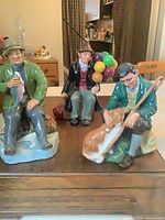 All three Royal Doulton figurines grouped on tabletop
