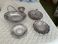 All four silverplate pieces grouped on table