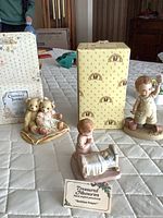 All three figurines with two boxes visible