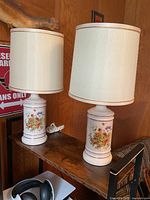 Both ceramic lamps with drum shades on table