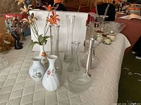 Group shot of all vases, bowl and decanter on table