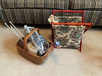 Overall view: wicker basket with yarn and needles beside folded wood frame knitting bag