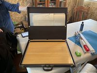 Open case showing drafting board and interior pocket