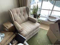 Full view of upholstered wingback chair in room