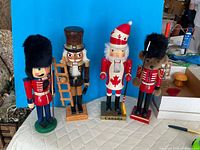 Group shot of all four wooden nutcrackers standing side by side