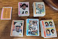 Stacks and spread of 1978 Topps football cards including players and checklist