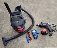 Group shot showing all items: Shop-Vac, hose with attachments, SKIL heat gun, battery with charger, Kobalt multimeter, Kobalt testers