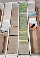 Box with three long rows of unsleeved football cards