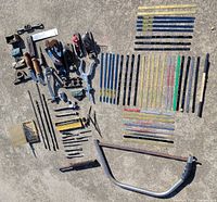 Entire lot laid out on concrete including planes, hacksaw frame, blades, bits and tools