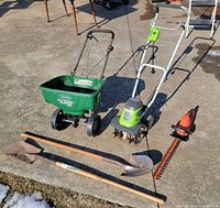 All five garden tools laid out on driveway