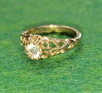 Profile view of gold electroplated filigree ring showing design details