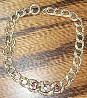 Full view of gold-tone bracelet showing overall design and clasp