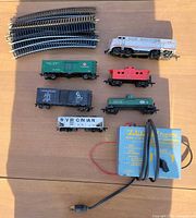 Entire lot showing locomotive, five cars, curved track stack and Varney controller