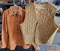 Front view of both garments hanging – L.L. Bean shirt and Eddie Bauer vest