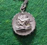 Front view showing Pieta relief and scalloped border