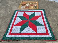Overview of both quilts laid flat outdoors