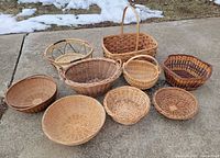 All nine baskets arranged on pavement, front and top views