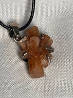 Close-up of aragonite crystal pendant with sterling silver prongs and bail