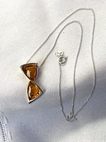 Full view of sterling silver chain with amber pendant