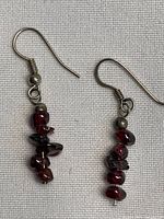 Front view of both earrings showing garnet chips and ear hooks