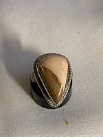 Front view of sterling silver ring showing pear-shaped picture jasper cabochon